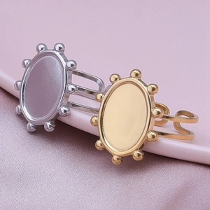 Detail of adjustable oval signet rings in gold and silver steel with beaded edges