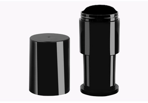 Detail of a portable retractable black makeup brush with soft bristles and a protective lid