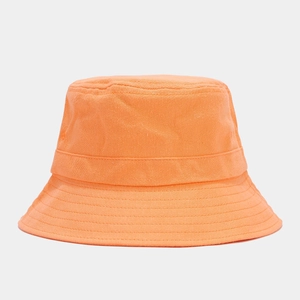 Detailed close-up of an orange cotton bucket hat showing reinforced brim stitching