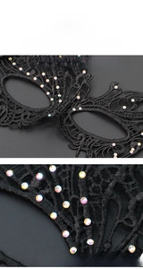 Close-up of black lace masquerade mask with intricate hollow design and rhinestones