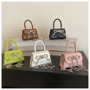 Mini crossbody bags with rhinestone bows and metal chain straps in five trendy colors