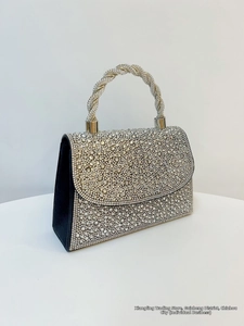 Detail of elegant black and white rhinestone handbag with twisted crystal handle