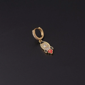 Detail of gold rocket earring with micro-pave zircons and red enamel finish on black backdrop