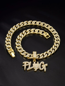 Detail of gold Cuban chain with iced-out PLUG pendant on black satin background