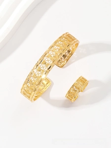 Detailed view of hollow gold-plated wheat leaf bangle and matching open ring set