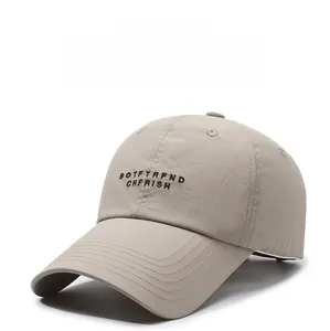 Close-up of embroidered letters and premium stitching on khaki sun protection baseball cap