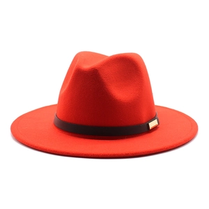 Detailed close-up of red felt fedora with black leather band and gold buckle detail