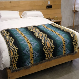 Detailed weave of Bohemian picnic blanket with geometric patterns and fringe edges