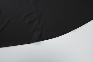 Close-up of the fine sewing craftsmanship and black fabric hem on the summer dress