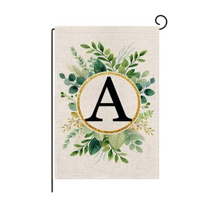 Garden flag with leaf wreath and letter A on black metal stand for outdoor decoration