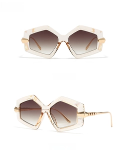 Front and 45-degree side view of oversized hexagonal sunglasses with champagne frames
