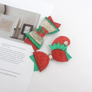 Detailed view of glitter Christmas hair bows in red, green and gold festive colors