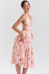 Detail of pink floral halter dress with deep V-neckline and open back summer design