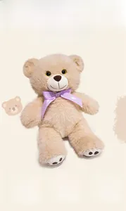 Close-up of plush teddy bear featuring soft fur and a purple bow tie with white polka dots