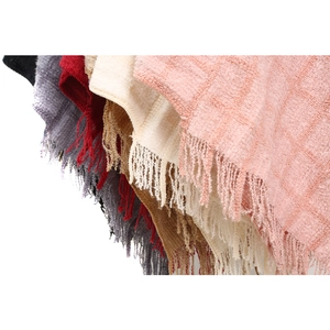 Chenille knit poncho with faux fur collar and plaid patterns in various colors
