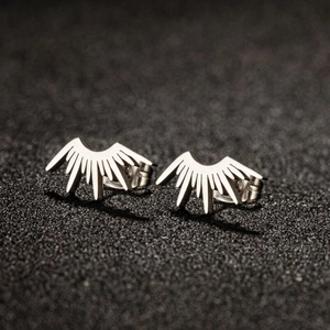Macro shot of silver fan-shaped stainless steel stud earrings with sunburst ray design
