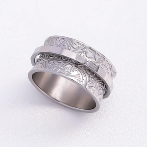Floral engraved wide band spinner ring in silver finish with a rotatable outer layer