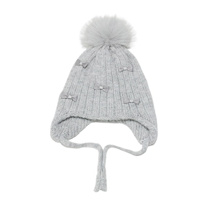 Detail of grey knit hat for girls featuring plush pompom and rhinestone bows
