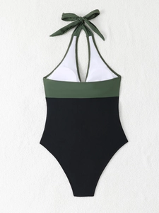 Detailed flat lay of a halter neck swimsuit in olive green and black color block style
