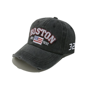 Detail of vintage washed gray baseball cap with Boston embroidery and distressed holes
