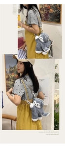 Detail of adjustable straps on a gray plush husky cartoon backpack worn by a model