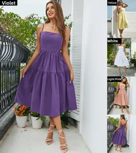 Detail of bohemian tiered maxi dress featuring a large bow tie back and pleated skirt layers