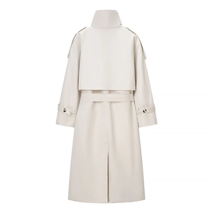 Rear view of a long beige trench coat featuring storm flap and waist belt details