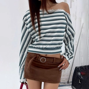 Detailed view of striped off-shoulder top with white lace trim and brown suede skirt