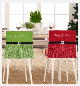 Detail of Christmas chair covers with sequins and Merry Christmas embroidery in a festive room