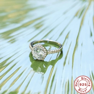 Macro view of 925 sterling silver halo engagement ring with brilliant round center diamond