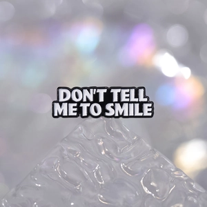 Funny cartoon alloy brooch with 'DON'T TELL ME TO SMILE' lettering on black metal enamel