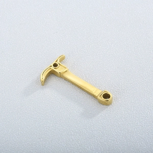 Detail of a golden stainless steel pickaxe pendant showing the polished metal surface