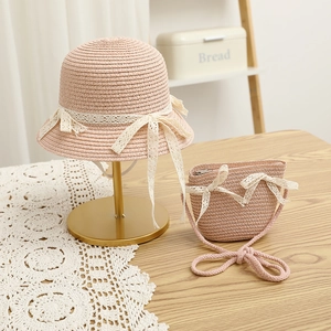 Pink straw sun hat and matching crossbody bag with lace bows for little girls