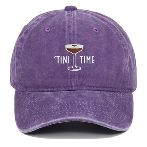 Close-up of the TINI TIME cocktail embroidery on a vintage washed purple baseball cap