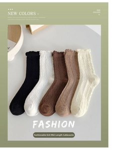 Detailed knit texture and frilly cuffs on stylish cotton crew socks in neutral tones