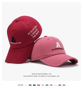 Detailed view of distressed baseball caps featuring vintage letter embroidery and cotton fabric