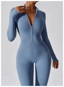Detail shot of blue high-stretch yoga bodysuit featuring a zip-up collar and sleek fit