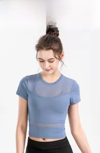 Detail of blue yoga top featuring breathable mesh panels and moisture-wicking fabric