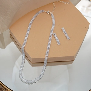 Detailed close-up of bridal jewelry set with rectangular cubic zirconia in silver finish