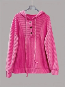 Close-up of ribbed texture and three-button neckline on a rose pink hooded sweatshirt