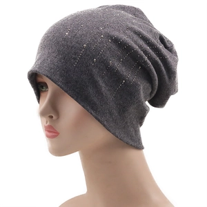 Detailed view of dark grey slouchy beanie featuring sparkling silver rhinestone accents
