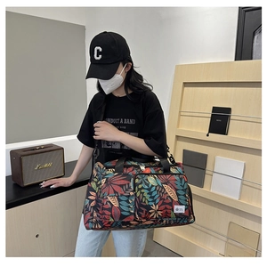 Travel tote bag featuring colorful feather patterns and large capacity for gym or sport
