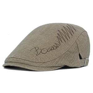 Detail of khaki cotton newsboy cap with embroidery and adjustable metal buckle