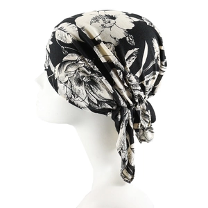 Women's pre-tied headscarf cap with black and white floral print on a white mannequin