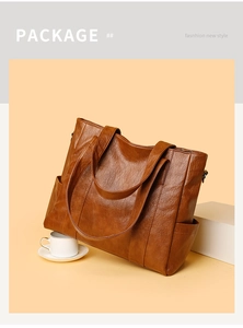 Detail of a large brown PU leather tote bag with soft texture for daily commuting