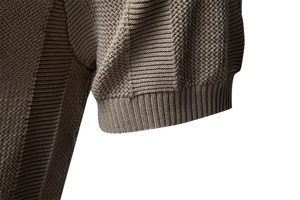 Close-up of dark brown knitted polo shirt showing rib knit cuffs and textured fabric