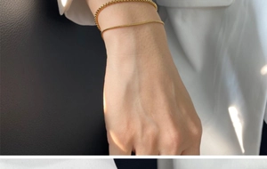 Wrist detail of gold-plated 316 stainless steel snake and box chain bracelet set