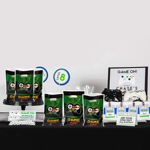 Green game themed party favor bags with controller icons and Game On text for birthdays