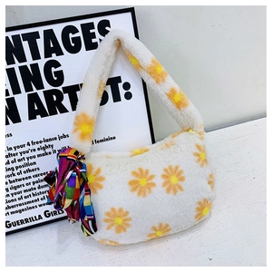 Detail of soft white plush daisy tote bag with yellow flowers and a colorful silk scarf wrap