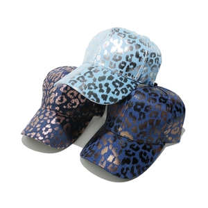 Baseball cap with metallic leopard print in blue and bronze colors on white background